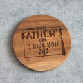 Wooden coaster with engraved text on a gray surface